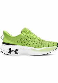 Chaussure de sport verte avec tige en maille respirante, accents noirs et une semelle intermédiaire épaisse blanche. Présente des lacets flexibles et un design texturé.