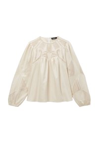Blouse crème avec de longues manches bouffantes, présentant des panneaux en maille transparente avec des motifs géométriques, détails froncés à l'ourlet et au col.