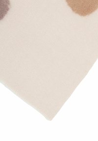 Light beige fabric with a soft texture, featuring abstract watercolor spots in taupe and warm brown, with a clean, neatly finished edge.