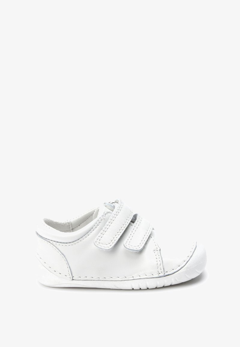 White leather shoe with two hook-and-loop straps, rounded toe, textured sole, and stitched detailing along the edges.