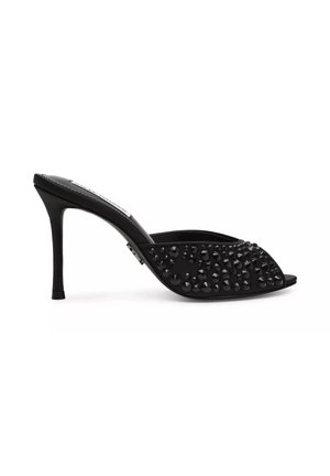 Black high-heeled mule with open toe, decorated with black shiny studs across the upper part.