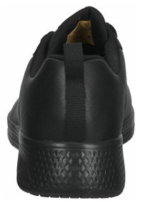 Scarpa sportiva nera con tomaia in sintetico liscio, suola in gomma testurizzata e linguetta sul tallone per facilitare l'indossamento.