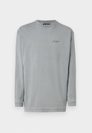 Szary, długi rękaw, wykonany z bawełny. Posiada okrągły dekolt oraz mały nadruk "SILENCE" na klatce piersiowej w ciemnoszarym kolorze. Gładka tekstura.