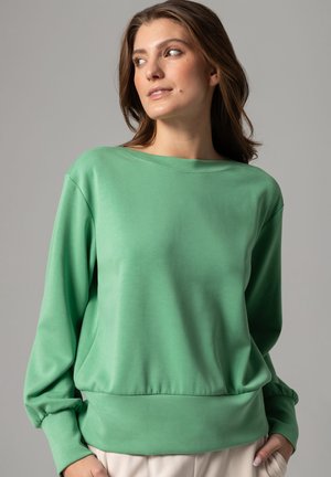 Green long-sleeve sweatshirt made of soft, smooth fabric with a relaxed fit, wide crew neck, and gathered accents at the cuffs and hem.