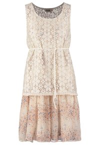 Lace sleeveless dress with cream top featuring floral pattern, waist tie, and a layered skirt in soft peach with blue and orange flowers.
