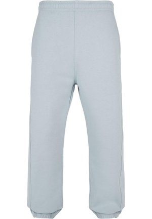 Pantaloni da jogging azzurri chiari realizzati in morbido tessuto, con una cintura elastica, polsini affusolati e dettagli sulle cuciture laterali. Texture liscia in tutto il capo.