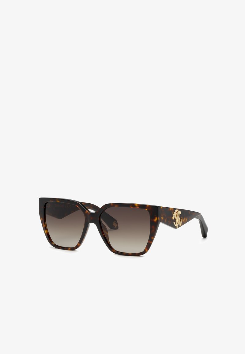 Lunettes de soleil carrées oversize écaille avec verres dégradés marron et logo décoratif doré sur des branches épaisses.