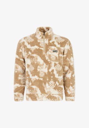 Fleece pullover i tan og crème med lynlås ved halsen, prydet med et tribal-mønster og en brystlomme med et logo-patch. Blødt, struktureret stof.