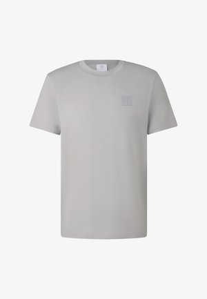 T-shirt gris clair en tissu lisse, avec un petit logo en relief sur le côté gauche de la poitrine et un col rond classique.