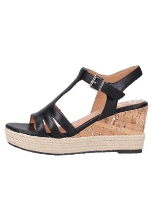 Sandalia negra de cuña de cuero con múltiples correas, tacón envuelto en corcho y suela de yute. El diseño del tacón ancho proporciona elevación.