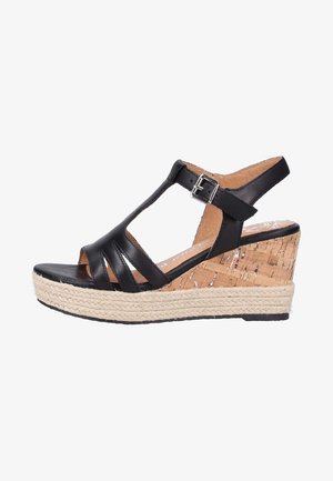 Sandale compensée en cuir noir avec plusieurs brides, talon en liège et semelle en jute. Le design du talon épais offre une élévation.