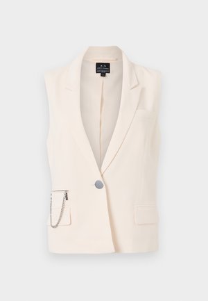 Sømløs kremfarget vest med skjortekrage, enkel knappelukking, sidelommer og en dekorativ kjede på lomme med glidelås.