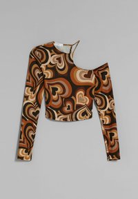 Long-sleeve crop top featuring a heart pattern in shades of brown, beige, and cream; cut-out detail on the left shoulder. Soft fabric.