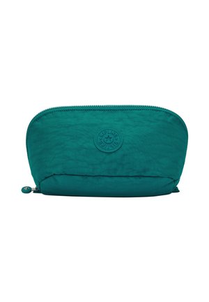 Taschen aus türkisem Stoff mit strukturierter Oberfläche, abgerundeter Form, Reißverschluss und einem auffälligen runden Logo auf der Vorderseite.