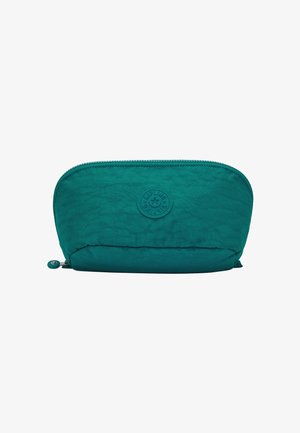Bolsa de tela azul verdoso con superficie texturizada, forma redondeada, cierre con cremallera y un logotipo circular prominente en el frente.