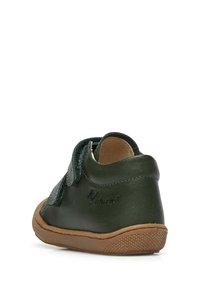 Scarpa verde in pelle con forma arrotondata. Presenta una fascia in Velcro e una suola in gomma texturizzata color ocra. Nessun motivo visibile o accenti aggiuntivi.