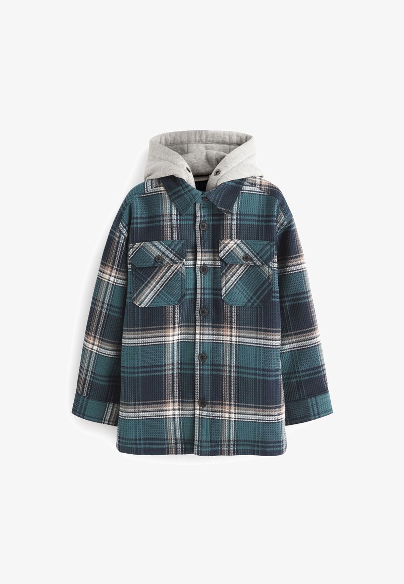 Veste en flanelle à carreaux teal et marine avec capuche grise, deux poches poitrine et fermeture à boutons. Texture douce, design décontracté.