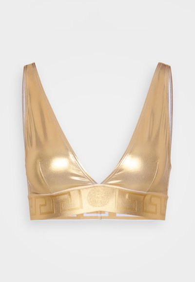 Bralette métallique doré avec un décolleté en V plongeant et des bretelles fines. Caractéristiques d'une bande décorative avec un motif de clé grecque en bas.