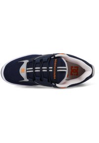 Navy blue sneaker with gray accents, rubber sole, and white laces. Features a logo near the heel and two white stripes on the tongue.