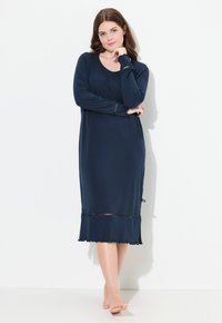 Granatowa nocna sukienka z długim rękawem, wykonana z miękkiego materiału. Posiada okrągły dekolt, koronkowy akcent u dołu oraz luźny krój.