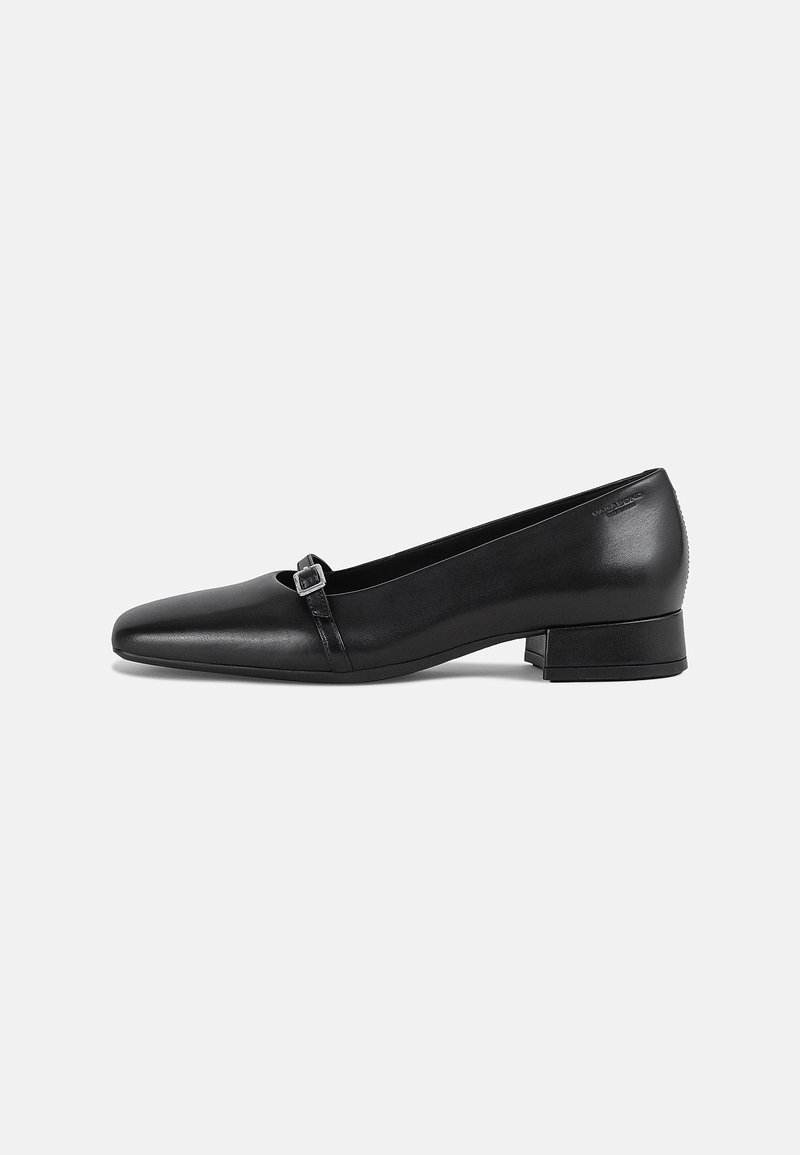 Chaussure plate en cuir noir avec un bout pointu et un petit talon carré. Présente une sangle décorative avec une boucle carrée pour le détail.