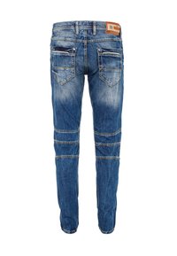 Blauwe denim jeans met een slim fit, voorzien van twee achterzakken, gestikte details en vervaagde plekken. Leren label op de tailleband.