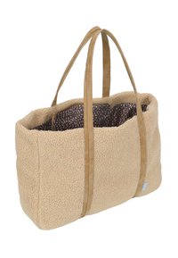 Tote bag in tan faux fur with leather straps. Features an interior with a dark brown lining and pink dotted pattern. Spacious design.