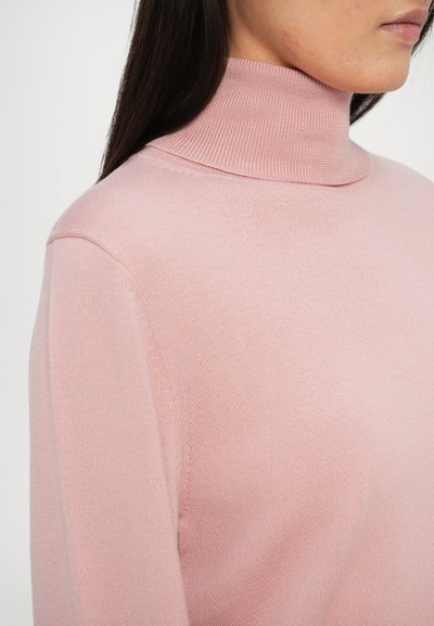 Maglione a collo alto rosa chiaro con texture a coste. Il design presenta un colletto alto aderente e maniche lunghe, realizzato in morbido tessuto a maglia.