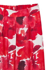 Jupe fleurie avec un motif rouge et blanc, fabriquée en tissu léger, dotée d'une taille froncée et d'un design plissé.