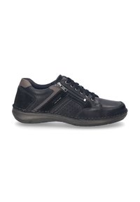 Zapato de cuero negro con acentos de textil, diseño de cordones, panel lateral perforado, tirador trasero y cierre de cremallera para facilitar su puesta. Suela de goma.