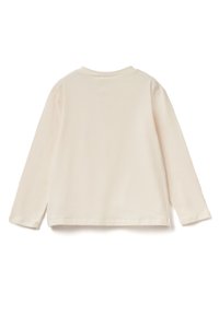 Halenka s dlouhým rukávem v světle béžové barvě, vyrobená z jemné látky. Má kulatý výstřih a postranní rozparky na lemu pro uvolněný střih. Hladká textura.