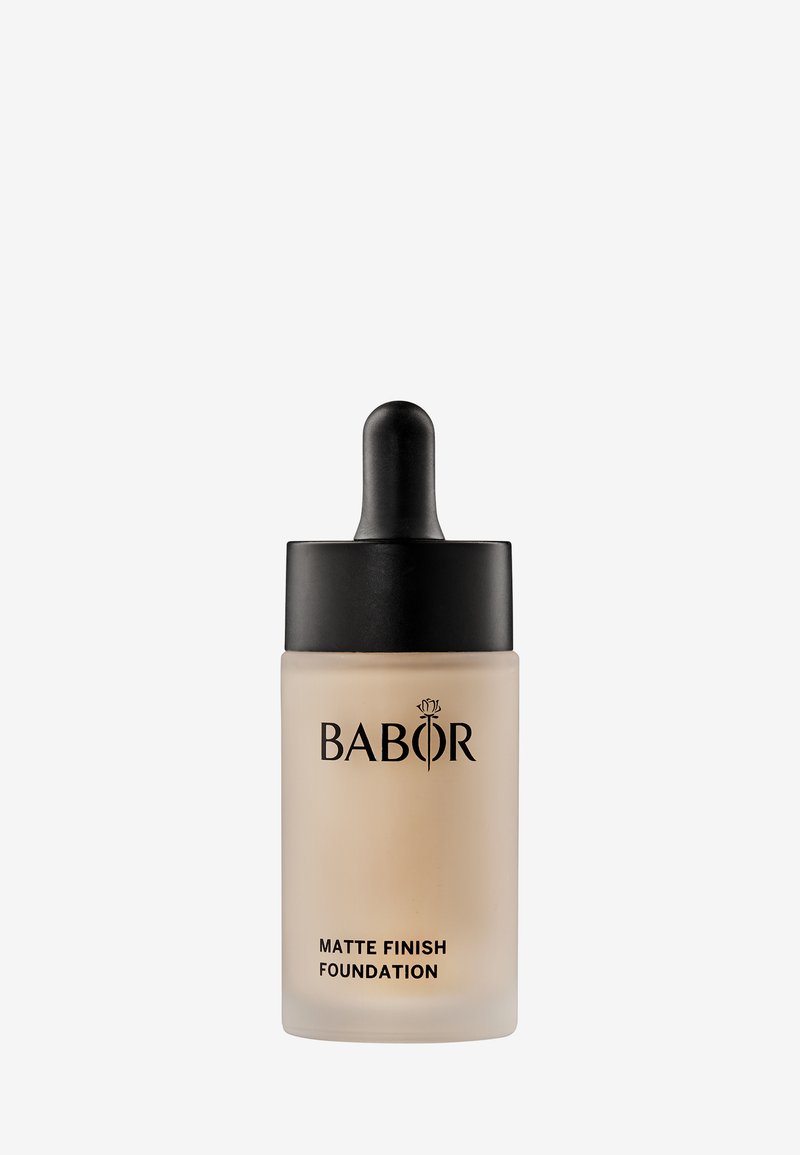 Foundation bottle with a dropper. Frosted glass body, matte finish, black lid, and branding in dark lettering on the front.