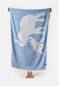 Light blue blanket featuring a white silhouette of an adult elephant and a baby elephant, with a textured finish and fringed edges.