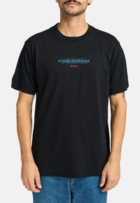 Black cotton t-shirt featuring a graphic print in blue and red text that reads "FUTURE MYTHOLOGY RVCA." Short sleeves and a crew neckline.