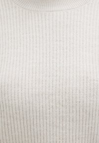 Cream-colored ribbed knit sweater with a high neckline, close-up showing texture and fabric pattern.
