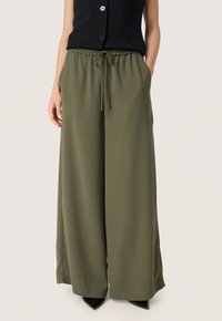 Olive green wide-leg trousers made of a soft fabric, featuring an elastic waistband with a drawstring and side pockets.