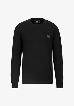 Pull noir à manches longues avec col rond, poignets et ourlet côtelés, avec une petite étiquette de marque rectangulaire sur le côté gauche de la poitrine.