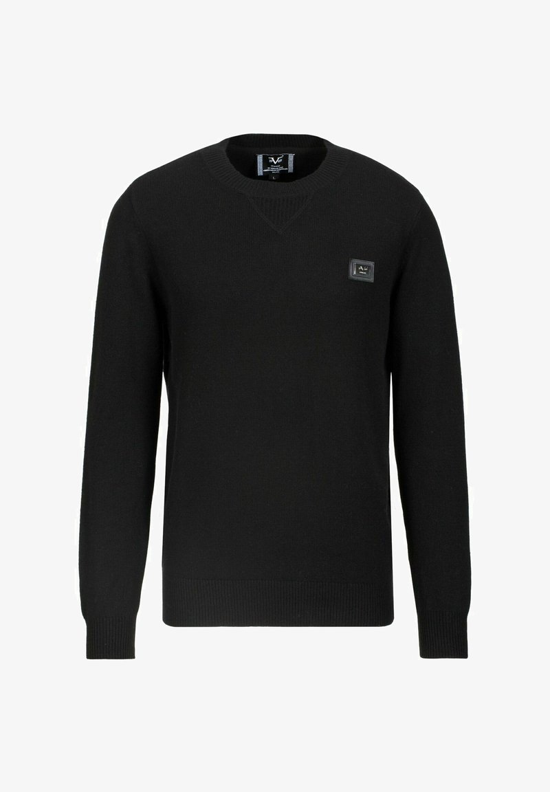 Pull noir à manches longues avec col rond, poignets et ourlet côtelés, avec une petite étiquette de marque rectangulaire sur le côté gauche de la poitrine.