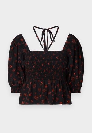 Black floral print blouse with puffed sleeves, smocked bodice, square neckline, and adjustable tie straps at the back.