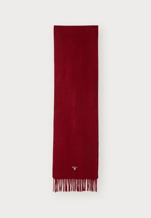Red wool scarf with a soft texture, featuring fringed edges and a small logo near the bottom. Rectangular shape for versatile wear.