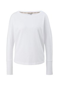 Chemise blanche à manches longues avec poignets côtelés et coupe ample, avec un col rond et une texture subtile du tissu.