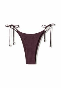 Bikini bottom in dark purple, featuring adjustable tie sides, textured fabric with small perforations, and bead accents on the ties.