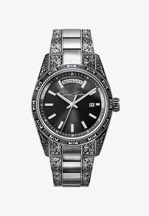 Orologio da polso argento con quadrante nero, indicazione del giorno e della data, cinturino e lunetta finemente incisi e firma "Thomas Sabo" sul quadrante.