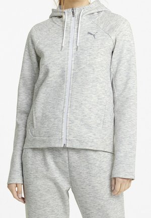 Sudadera con cremallera de color gris claro, fabricada en tejido texturizado con diseño deportivo, con un bolsillo tipo canguro y capucha ajustable. Logo de Puma en el pecho.