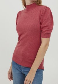 Pullovertröja i heathered rosa med mock neck, korta puffärmar och en figurnära silhuett. Tillverkad av mjukt, strukturerat stickat tyg.