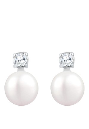 Boucles d'oreilles en perles avec une base en perle ronde blanche et un bijou rond transparent au-dessus, montées en métal argenté.