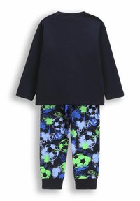 Dwu-elementowy strój dla dzieci z jednolitą granatową bluzką z długim rękawem oraz spodniami w nadruki z zielonymi i niebieskimi piłkami do futbolu oraz plamami farby.