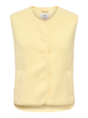 Kollane fliisvest ümmarguse kaelusega, ees käepaelade ja kahe küljetaskuga. Pehme tekstuuriga, hubase välimusega ja varrukateta.