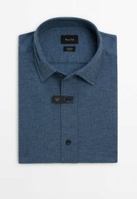 Chemise bleu slim fit à manches longues pliée, avec un motif texturé et une fermeture boutonnée à l'avant, présentée sur fond blanc.
