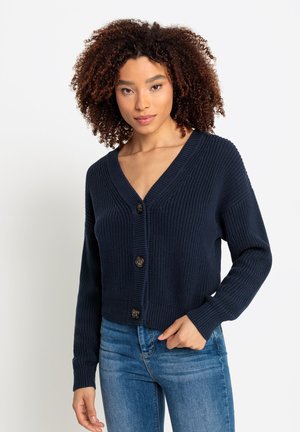 Cardigan lavorato a maglia blu navy con scollo a V, dotato di chiusura con bottoni e maniche lunghe. Tessuto a trama con polsi e orlo a coste.